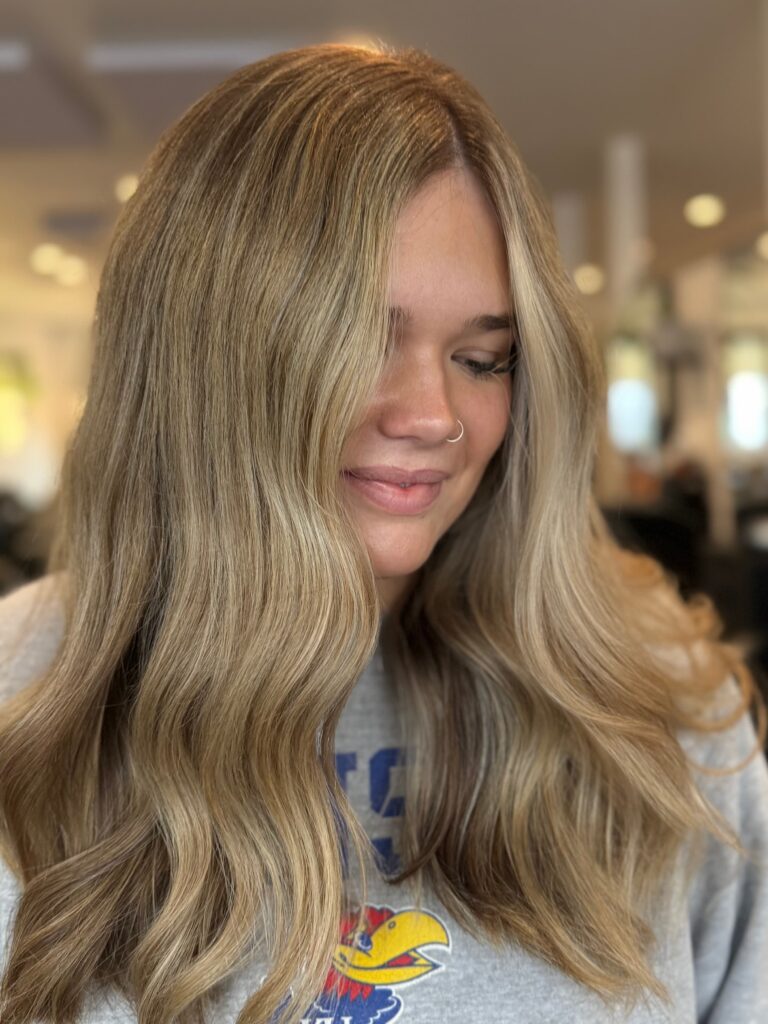 Blonde balayage hairstyle with soft curls