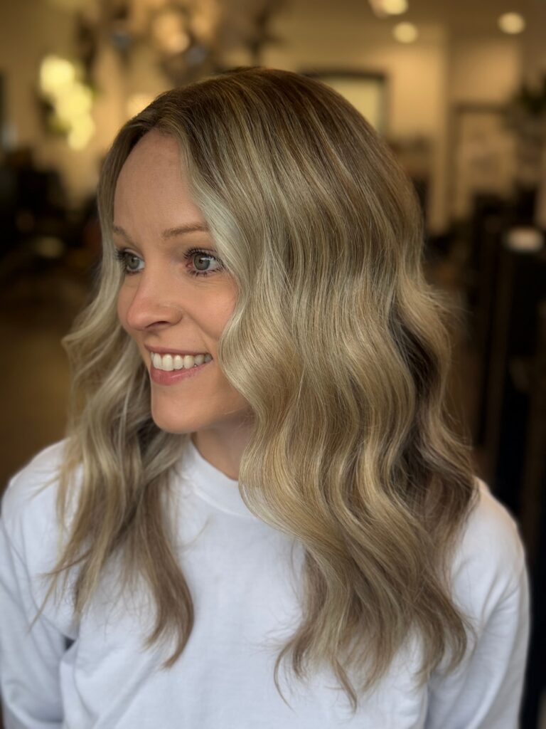 Blonde balayage hairstyle with face framing highlights
