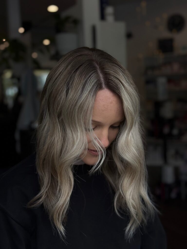 Blonde balayage with middle part hairstyle