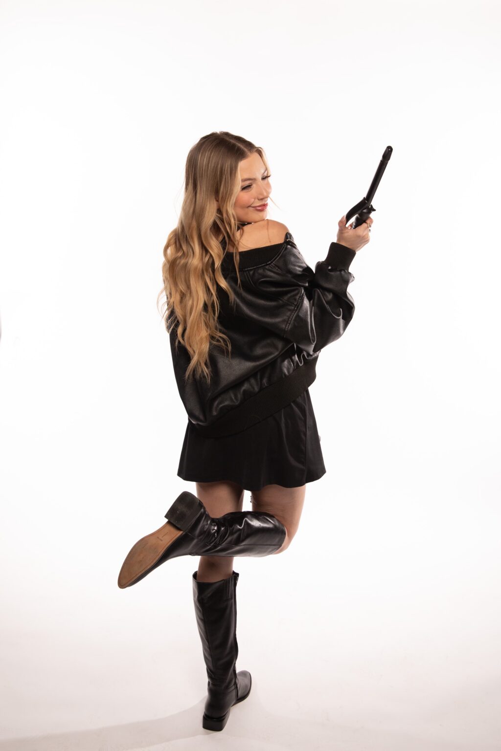 portrait of ella from behind holding hair curler